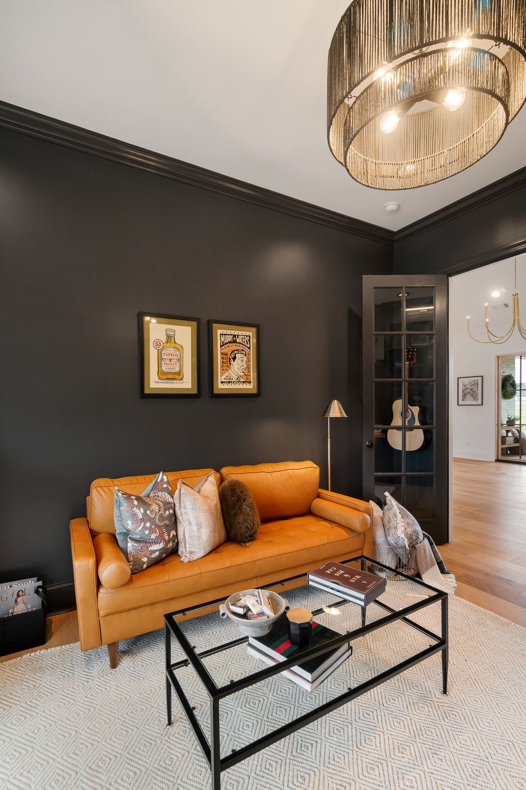 Sitting room in charcoal, with the pocket door open through to the dining area.