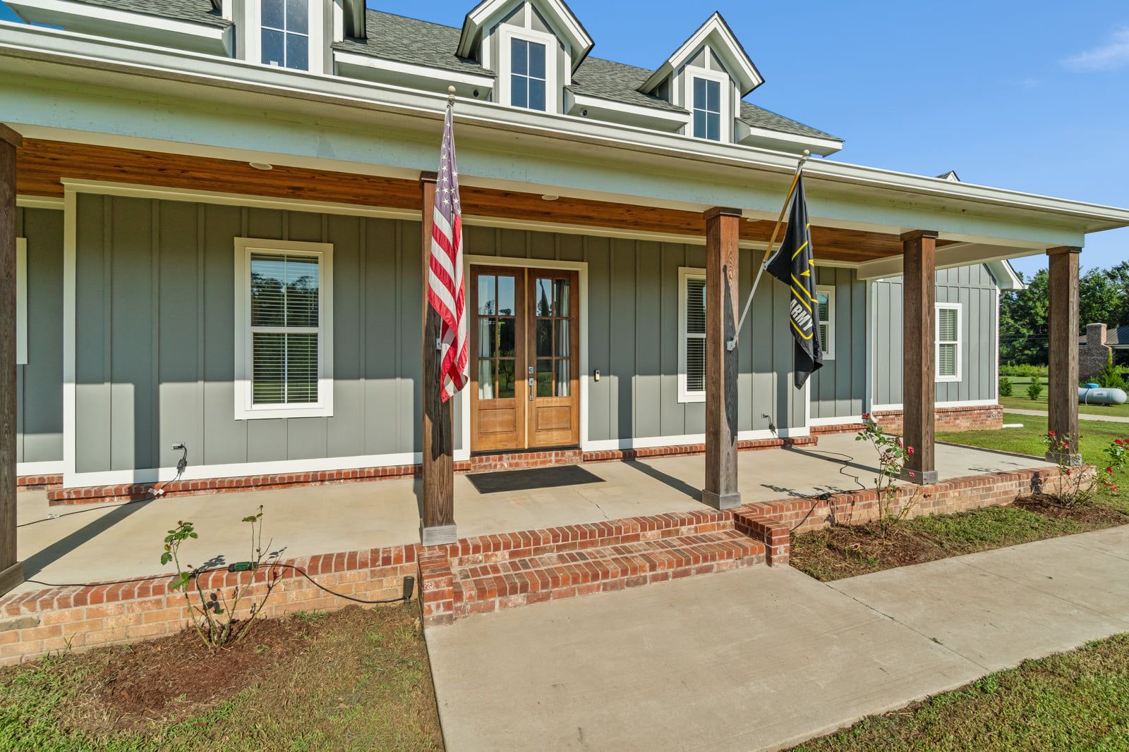 Covered porch running the front of the house, with the entry door centred.